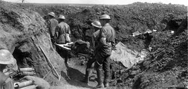Australian stretcher bearers carrying wounded back along the trenches – with permission from the Australian War Memorial site