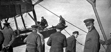 A seaplane being winched aboard its tender