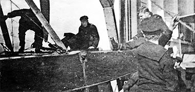 A seaplane being winched aboard its tender