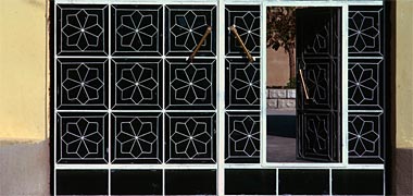 Detail of steel entrance gates with open wicket gate