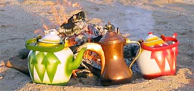 Chinese tea pots and a della by a desert camp fire