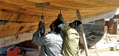 An electric drill being used in the construction of a dhow