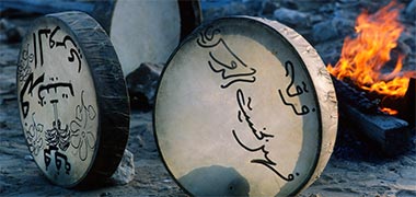 Drums being warmed in front of a fire