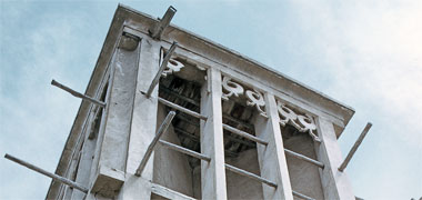 A wind tower with three decorated divisions at its head