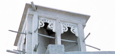 A wind tower with decorative perforated carved plaster work in the openings