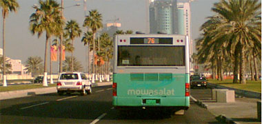 A green bus en route