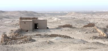 The ruins of a house and its containing wall in the north of the country