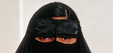 A young woman wearing a badu mask