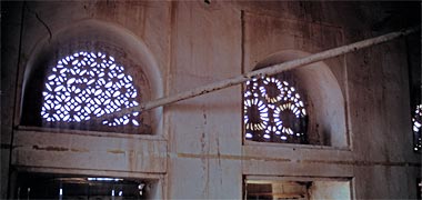 An internal view of carved naqsh ventilation panels in an old Wakra building