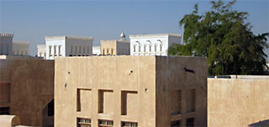 Looking north-west over buildings in a traditional style in Wakra