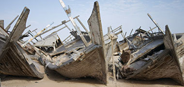 Beached fishing boats rotting