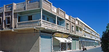 A row of houses with ground floor retail units photographed in 1972