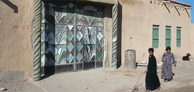 A pair of steel entrance gates with decorated surround