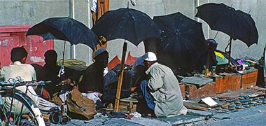 Shoe menders outside the suq’s main mosque, April 1972