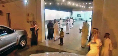 Guests to a wedding being greeted at the gate with aoud burning in a midkhan