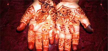The hands of a young girl dyed with henna