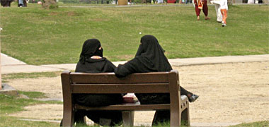 Two Qatari women talking in a park 