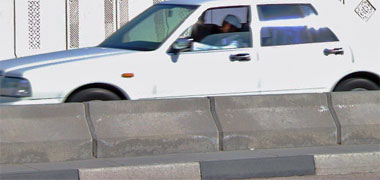 A vehicle barrier illustrating its height compared with a car
