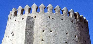 A detail of the decorated top of a corner tower at Wajbah