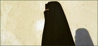 Woman walking near a wall