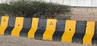 A yellow and black decorated vehicle barrier – with the permission of kattbee on Flickr