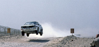 Rally car driving in the desert, 1987