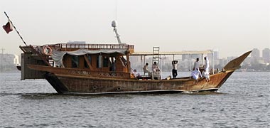 A converted traditional boat moving out to sea
