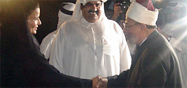 Sheikha Moza, wife of the Ruler, Sheikh Hamad, shaking hands with Sheikh Yusef Qaradawi 