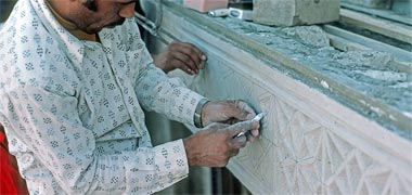 A craftsman working on the running naqshwork, January 1976