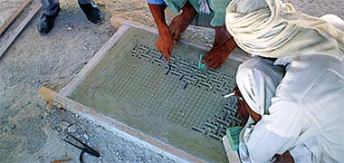 Naqsh plasterwork being carved in a frame