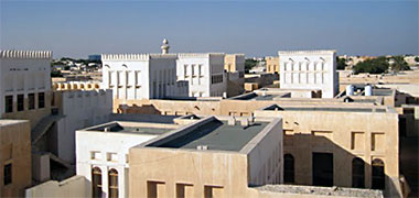 Looking north over buildings in a traditional style in Wakra