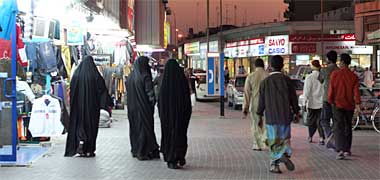 People moving at night around the shops in the area of the Wadi Sail