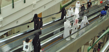 Male and female Qataris shopping in a modern centre