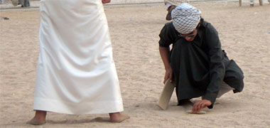 Two boys playing al-qleena wa al-matuwa’