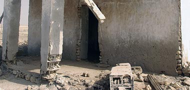 Damage to the base of an old building at al-Ruwaidha