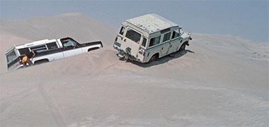 Two cars stuck on top of a dune, 1979