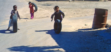A boy rolling a tyre