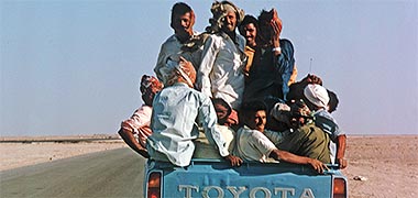 Workers being transported on the North Road in a pickup, 1973