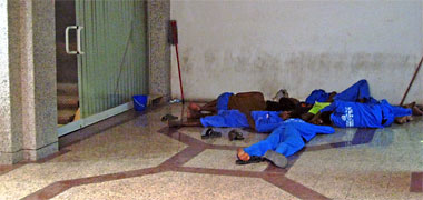 Workers asleep on the floor of a building